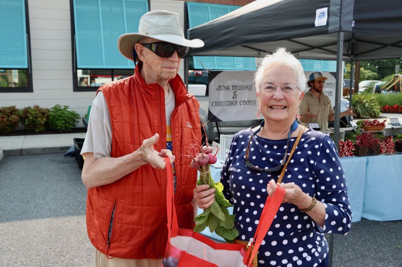 John Hawkins, left, and Sylvia Ritchie of Lewes bought fresh turnips, and more from Cosmic Dog Farms.